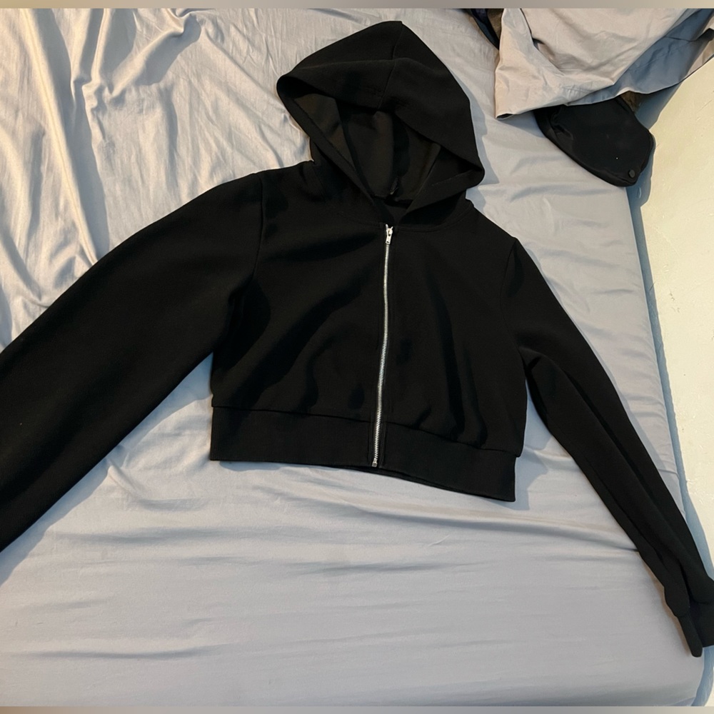 Black hooded crop top jacket.